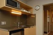 Kitchen with cooktop and microwave